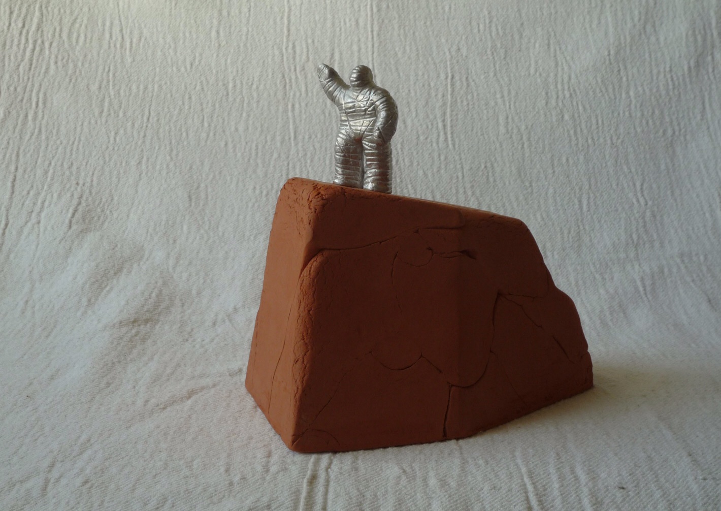 Aluminium figure on terra-cotta base. Approx. 12cm overall 